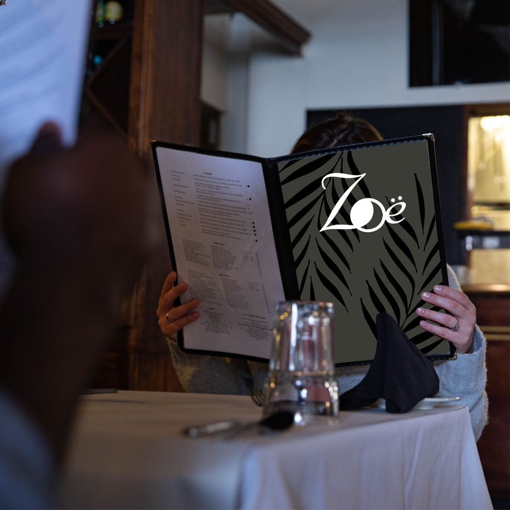photo of a diner reading the menu before ordering at Zoe